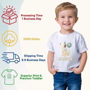 May include: A white toddler t-shirt featuring a watercolor illustration of a Dalmatian dog wearing a party hat and holding a number 3 balloon. The name "JACOB" is printed below the dog.