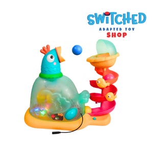 May include: A colorful adapted toy with a chicken-shaped base and a spiral slide. The toy features a blue ball, lights, and the text "SWITCHED ADAPTED TOY SHOP". The slide has small yellow bird figures.