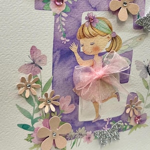 May include: A purple letter E with a watercolor design and a fairy with pink wings and a pink bow. The letter is surrounded by flowers and butterflies.