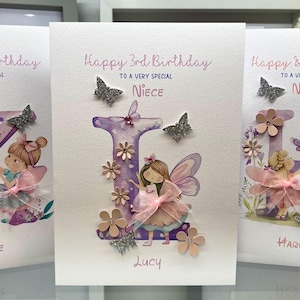 May include: Three handmade birthday cards featuring a purple letter, a fairy, and flowers. The cards say "Happy 3rd Birthday to a very special Niece" and include the names Katie, Lucy, and Harriet.