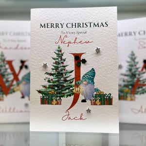 Biglietto di Natale personalizzato per nipote. Qualsiasi nome, biglietto di Natale per relazione. Decorato a mano con agrifoglio 3D, stelle 3D e gemme. Biglietto di Natale per nipote