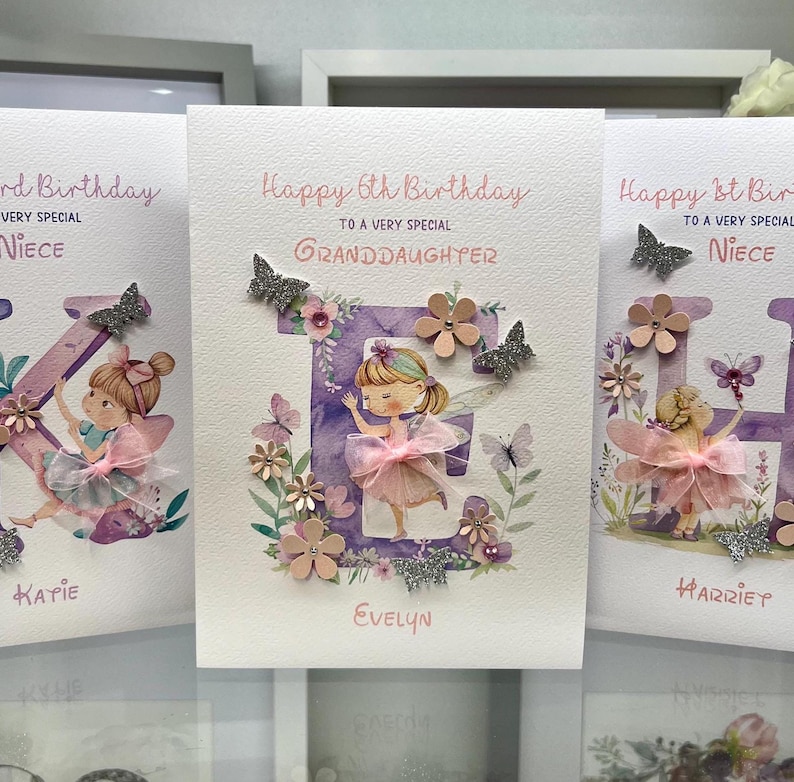 May include: Three handmade birthday cards with a purple letter, a fairy, and flowers. The cards say "Happy 6th Birthday to a very special Granddaughter", "Happy 1st Birthday to a very special Niece", and "Happy 1st Birthday to a very special Niece".