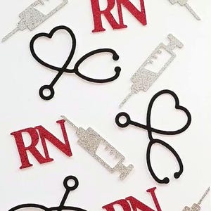 May include: Assortment of glittery medical-themed cutouts. Includes red glitter "RN" letters, silver glitter syringes, and black stethoscopes with heart-shaped elements. Ideal for crafting or medical-themed decorations.