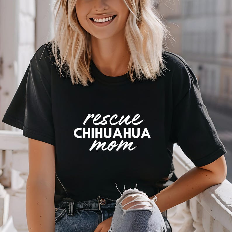 May include: Black t-shirt with white text that reads "rescue chihuahua mom".