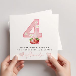 May include: A pink card with a watercolor illustration of the number four with strawberries and flowers. The card says "Happy 4th Birthday to a berry special daughter Amelia".