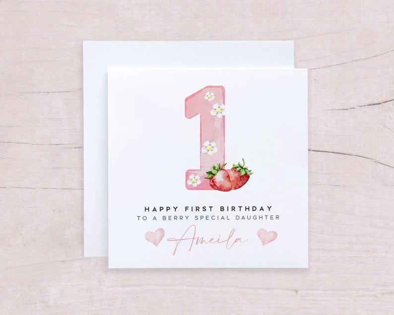 May include: Pink and white birthday card with a number one, strawberries, and the text "Happy First Birthday to a Berry Special Daughter Amelia".
