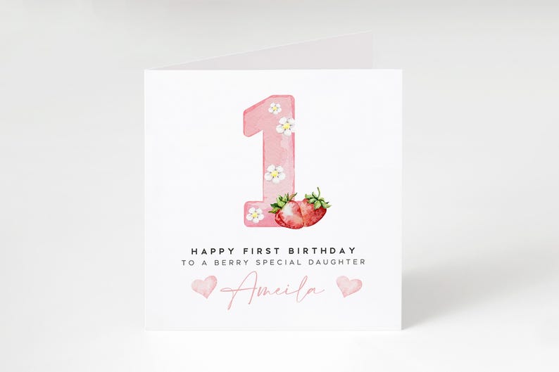 May include: Pink card with a watercolor illustration of the number one with strawberries and flowers. The text reads "Happy First Birthday to a Berry Special Daughter Amelia".
