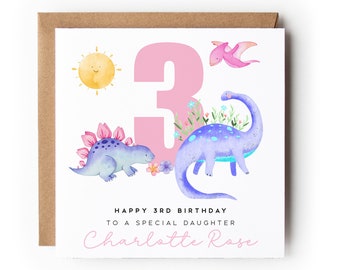 May include: A pink and white birthday card with a pink number 3, a sun, and two dinosaurs. The card says "Happy 3rd Birthday to a special daughter Charlotte Rose".
