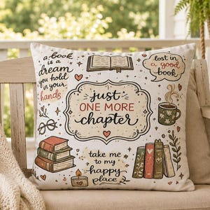 May include: A square throw pillow with a cream background featuring colorful illustrations of books, a steaming mug, glasses, and a candle. The text reads: a book is a dream you hold in your hands, lost in a good book, just one more chapter, take me to my happy place.