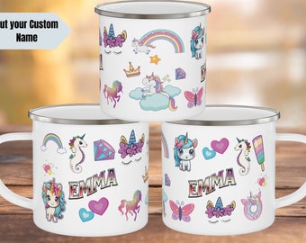 May include: Three white enamel mugs with a silver rim. Each mug features a different design of colorful unicorns, rainbows, hearts, stars, and butterflies. The mugs are personalized with the name "Emma".