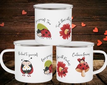 May include: White enamel mugs with silver rims, featuring ladybug and floral designs. Each mug has a different inspirational phrase: "Love yourself Time", "Treat others with Kindness", "Be kind to yourself", "Give yourself", and "Continue Growing".