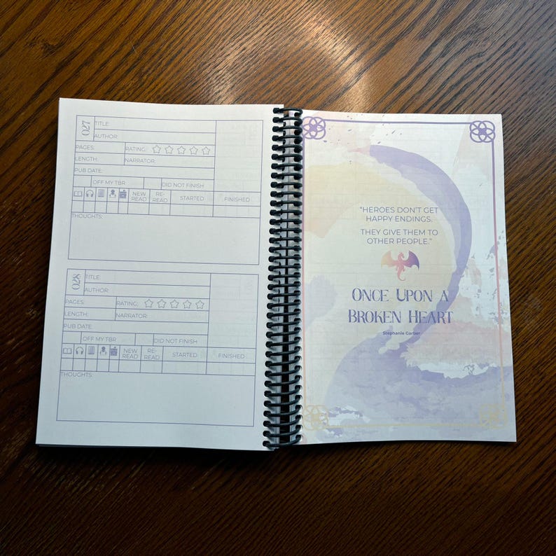 May include: A book with a purple and blue watercolor design on the cover. The title of the book is "Once Upon a Broken Heart" by Stephanie Garber. The book cover also features a quote: "Heroes don't get happy endings, they give them to other people."