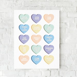 May include: A printable wall art design featuring 15 colorful heart-shaped candy conversation hearts with various humorous and romantic phrases. The hearts are arranged in a grid pattern on a white background.