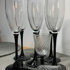 Luminarc 1980 champagne glasses plus two liqueur glasses.