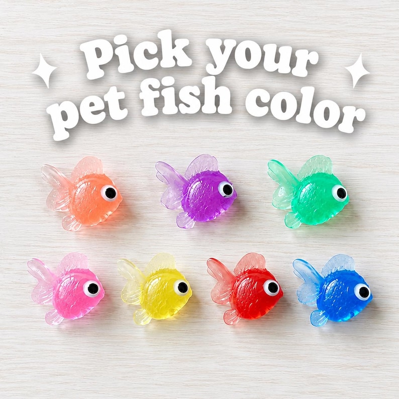 May include: Seven small, translucent plastic fish figurines with googly eyes, arranged in two rows. The fish are colored orange, purple, green, pink, yellow, red, and blue. The text "Pick your pet fish color" is printed in white above the fish.