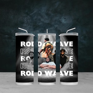 May include: A set of three black and white tumblers featuring images of Rod Wave. The tumblers have a white straw and the words "ROD WAVE" in a vertical design. The design includes images of Rod Wave in a spotlight.