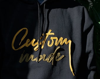 handcrafted custom shoelace lettering on a sweatshirt