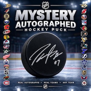 May include: A black hockey puck featuring a silver autograph and the number 7, centred against a background with the text MYSTERY AUTOGRAPHED HOCKEY PUCK and various NHL team logos arranged in two vertical columns on the left and right sides.