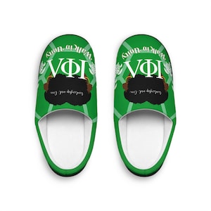 May include: A pair of green and white slippers. The slippers display the Greek letters VΦI, a woman's face, and the words "Walk in Unity" and "Leadership and Love." The slippers have a white interior and a green exterior with a geometric pattern.