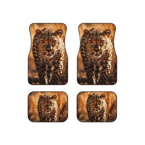 May include: Set of four car floor mats featuring a close-up image of a leopard walking towards the camera. The mats are brown with a light brown background.