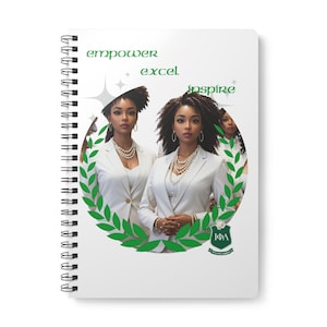May include: White spiral-bound notebook with a design of three women in white blazers and pearl necklaces. The words "empower excel inspire" are in green script above the image. A green laurel wreath surrounds the women, with a crest at the bottom.