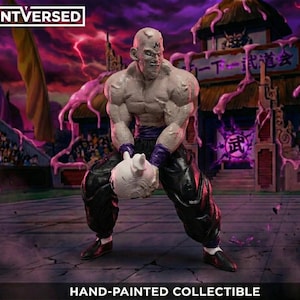 May include: A hand-painted collectible figure of a muscular character with a bald head and black trousers, holding a white object. The figure is set against a detailed background with Japanese text and a purple and pink colour scheme. The Printversed logo is in the top left.