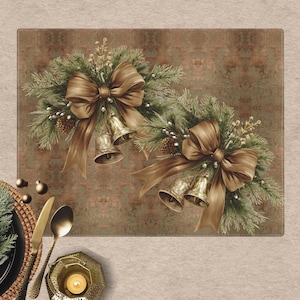 May include: A rectangular placemat with a festive design. It features two arrangements of green pine branches, gold bows, and gold bells. The background is a mottled brown. A pine cone, plate setting, and candle are in the foreground.