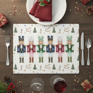 May include: A festive table setting with a white plate, red napkin, and a placemat featuring nutcracker soldiers. The placemat has a repeating pattern of toy soldiers, rocking horses, and Christmas trees. Silverware and wine glasses complete the holiday scene.