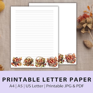 Peut inclure: Papier à lettres imprimable sur le thème de l'automne. Le papier a une zone d'écriture lignée et une bordure de paniers remplis de pommes rouges et de feuilles d'automne.