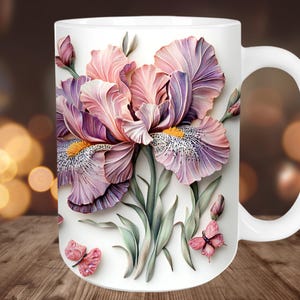May include: White ceramic mug with a floral design of pink and purple irises, green leaves, and pink butterflies. The mug has a large, curved handle. Suitable for hot or cold drinks, it's a decorative item.