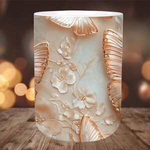 May include: A cylindrical decorative lamp with a cream-colored background. The lamp features a relief design of butterflies and flowers in shades of gold and cream. The lamp is placed on a wooden surface.