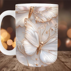 May include: White ceramic mug with a design of two white butterflies with gold accents and rhinestones. The butterflies are on a white background with gold floral accents.