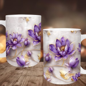 May include: White ceramic mug featuring a design of purple lotus flowers with gold accents. The flowers are set against a textured, off-white background. The mug has a large, curved handle.