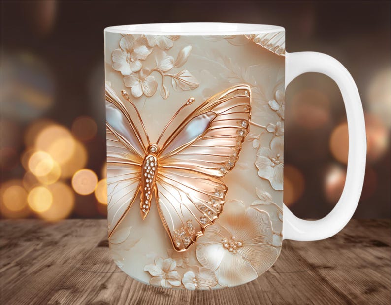 May include: White ceramic mug featuring a detailed, embossed design of a butterfly with gold and pearl accents, surrounded by floral elements. The mug has a white handle and a cream-colored background.