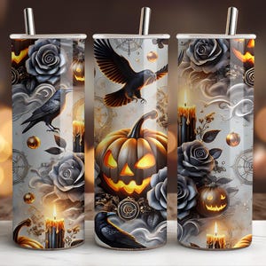 May include: A Halloween-themed tumbler featuring a jack-o'-lantern, crows, roses, and candles. The design includes a crow in flight, a smiling pumpkin, and a vintage compass. The tumbler has a silver straw and a white background.