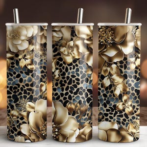 May include: Three stainless steel tumblers with lids and straws. The tumblers feature a floral design in shades of gold and cream, set against a black and brown leopard print background. The design wraps around the entire tumbler.