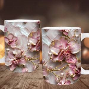 May include: Two white ceramic mugs featuring a pink and gold floral design. The design depicts pink orchids with gold accents and pearl-like details on a white background.