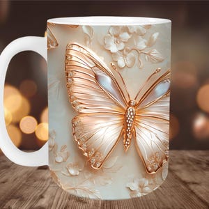 May include: White ceramic mug featuring a detailed, embossed butterfly design with gold accents and pearl-like wings. The butterfly is surrounded by floral elements on a cream-colored background. The mug has a white handle.