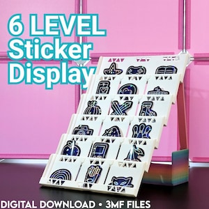 May include: A white 6-level tiered display stand holding various holographic stickers. The stand features a rainbow-colored base and triangular cutouts along the edges. Text on the image reads 6 LEVEL Sticker Display and DIGITAL DOWNLOAD 3MF FILES.