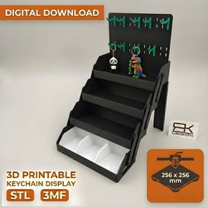 May include: Black 3D printable keychain display with multiple shelves and a pegboard top. The display has a white interior and includes the text "3D PRINTABLE KEYCHAIN DISPLAY STL 3MF". The display is 256 x 256 mm.