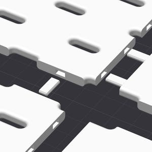 May include: A series of white, rectangular modular panels featuring rounded corners and elongated oval cutouts. Each panel has small, rectangular connector tabs along the edges, arranged in a grid pattern against a dark gray background.
