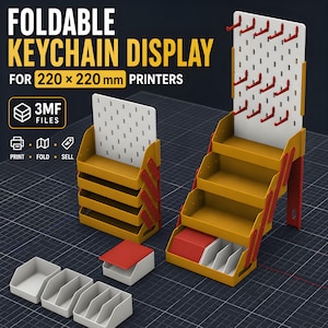 Op de afbeelding: Een opvouwbare displaystandaard voor sleutelhangers voor 220 x 220 mm printers, met gele planken, een wit geperforeerd bord met rode haken en extra witte opbergbakjes. De tekst luidt FOLDABLE KEYCHAIN DISPLAY FOR 220 x 220 mm PRINTERS.