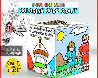 May include: A paper cube craft featuring illustrations and text about Paul and Lydia. The cube displays scenes of a church, a sun, and figures, with text stating, She invited Paul and his companions to stay at her home and Paul met Lydia.