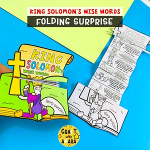 May include: A colorful, folded paper craft featuring the text "KING SOLOMON'S WISE WORDS FOLDING SURPRISE." The craft includes illustrations of King Solomon and Bible verses. The design incorporates bright colors and a cross symbol.