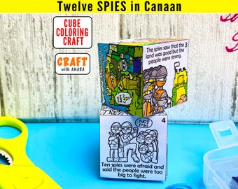 May include: Two paper cubes featuring black and white line art illustrations and text about the Twelve Spies in Canaan. The top cube is partially colored in green, orange, and blue. The bottom cube shows a scene with the text Ten spies were afraid and said the people were too big to fight.