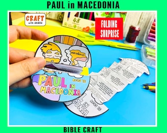 May include: A circular paper craft titled Paul in Macedonia Acts 16 featuring a folding accordion insert with black and white illustrations and text detailing biblical stories. The craft includes colorful text and cartoon drawings of figures.