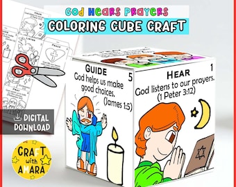 May include: A paper coloring cube craft titled God Hears Prayers featuring illustrated panels with religious text and figures. One side shows a person praying with a book and moon, another shows a figure with a candle. Includes a digital download sheet.