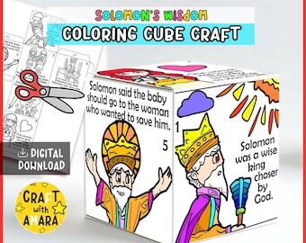 May include: A white cube craft with colorful illustrations and text related to Solomon's Wisdom. The cube features images of Solomon and text that reads, "Solomon said the baby should go to the woman who wanted to save him."
