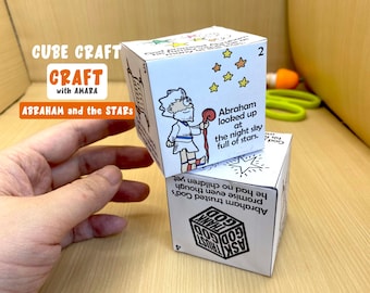 May include: White cube craft with illustrations and text. The cube features a drawing of Abraham looking at stars, with the text "Abraham looked up at the night sky full of stars." The cube also has the text "CUBE CRAFT CRAFT with AMARA ABRAHAM and the STARS."