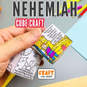 May include: A paper cube craft featuring a colorful illustration of a man in a purple tunic standing before a yellow stone wall with the text Nehemiah 1 heard Jerusalem's walls were broken, and his heart was deeply troubled, alongside a black and white side.